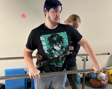Patient Michael Wall practicing balance with his new orthotics.